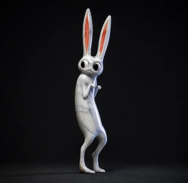 TICK, a white marble, coral inlay creature, photographed as a specimen on a dark ground.